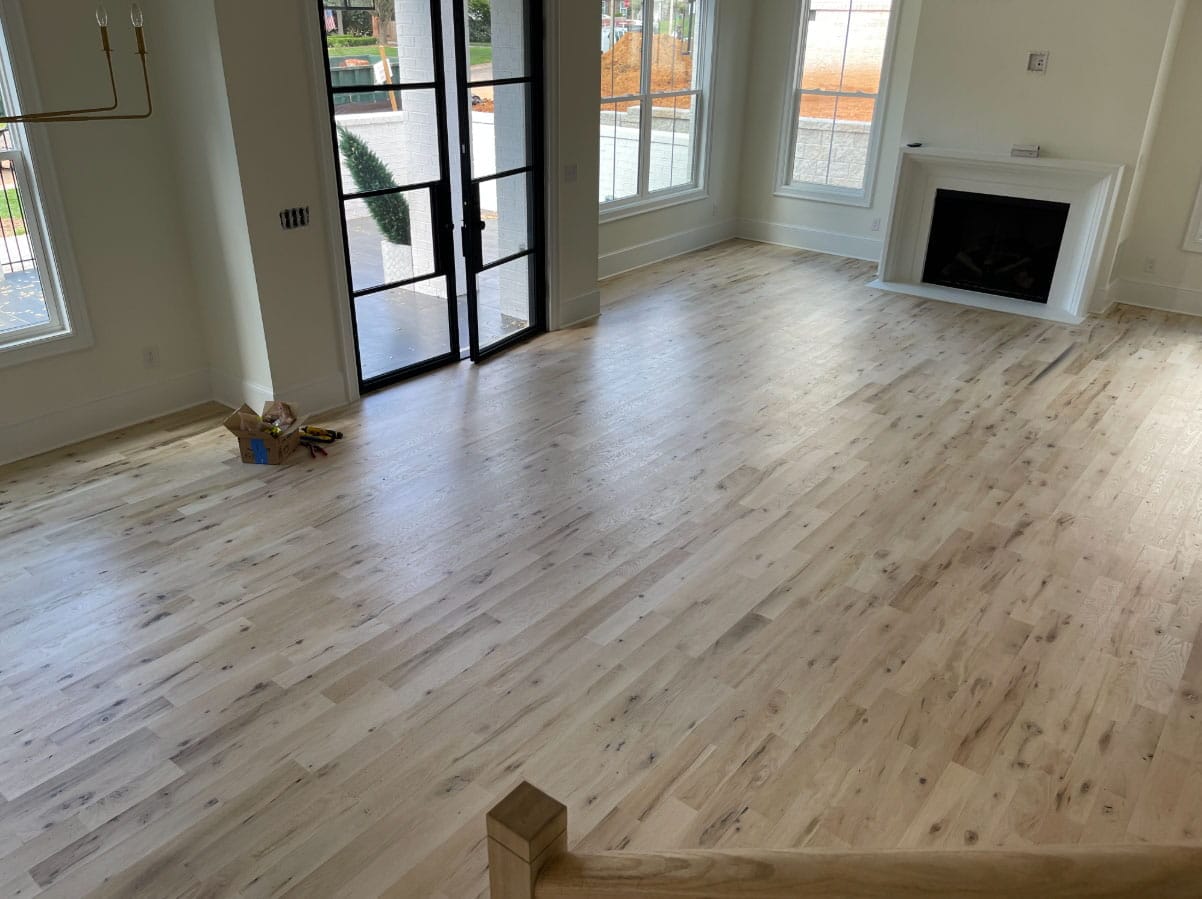 Light natural hardwood floor installation in modern Charlotte NC home interior