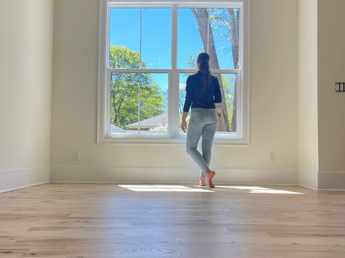 Hardwood floor refinishing restoring natural wood beauty in a bright modern home interior