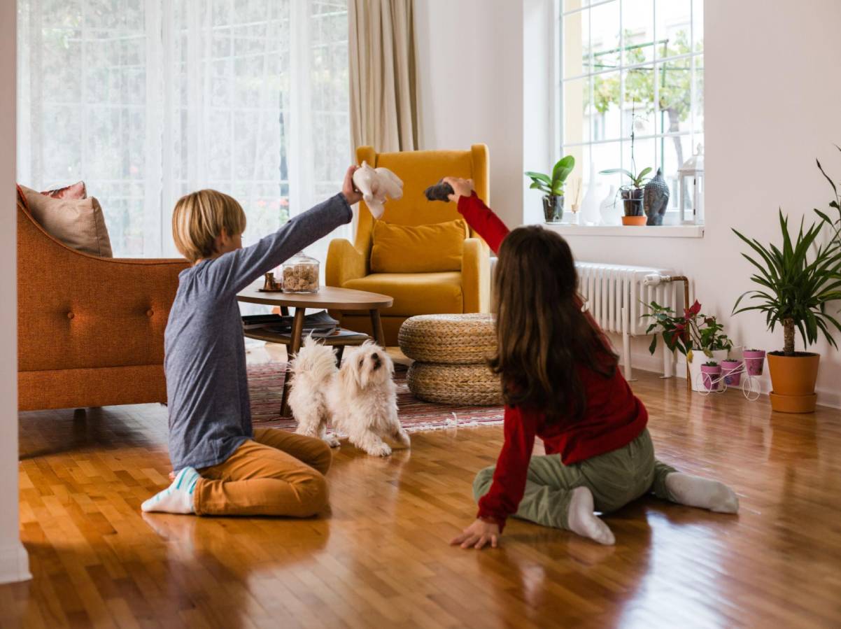 kids and pet playing on clean hardwood flooring in high traffic home